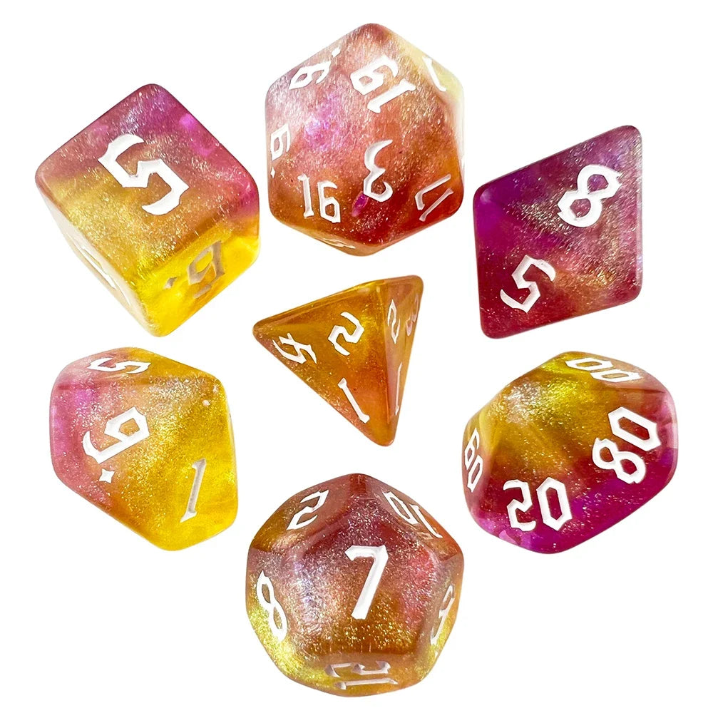 7-piece polyhedral dice set with a golden-yellow to magenta gradient and white numbers, on a white background